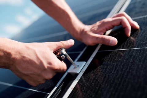 Professional technician reviewing solar system components