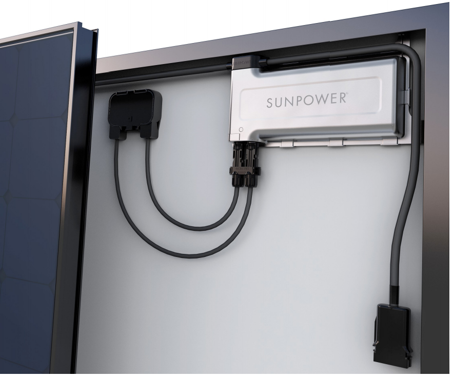 Micro-inverter mounted behind a solar panel